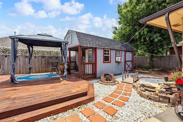 704 N Geronimo Way, Mustang, OK 73064 - wooden deck with a gazebo, a fenced backyard, an outdoor structure, and cooling unit