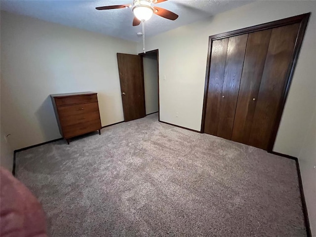 3014 S Mission St, Anadarko, OK 73005 - unfurnished bedroom featuring light carpet, a closet, and ceiling fan