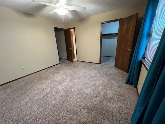3014 S Mission St, Anadarko, OK 73005 - unfurnished bedroom featuring light carpet, a textured ceiling, ceiling fan, a spacious closet, and a closet