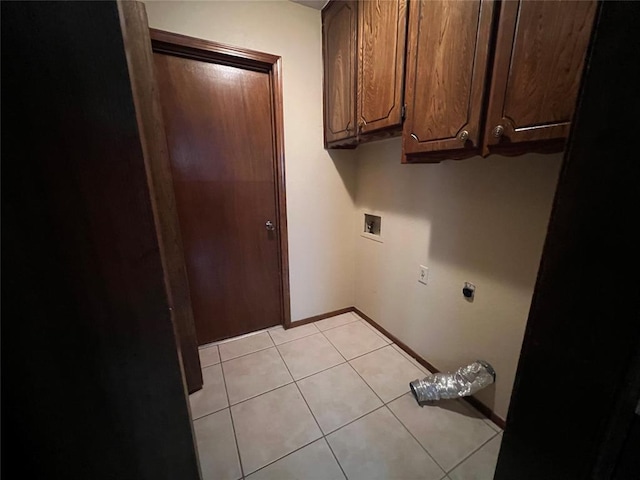3014 S Mission St, Anadarko, OK 73005 - laundry room featuring cabinet space, hookup for an electric dryer, hookup for a washing machine, and light tile patterned floors