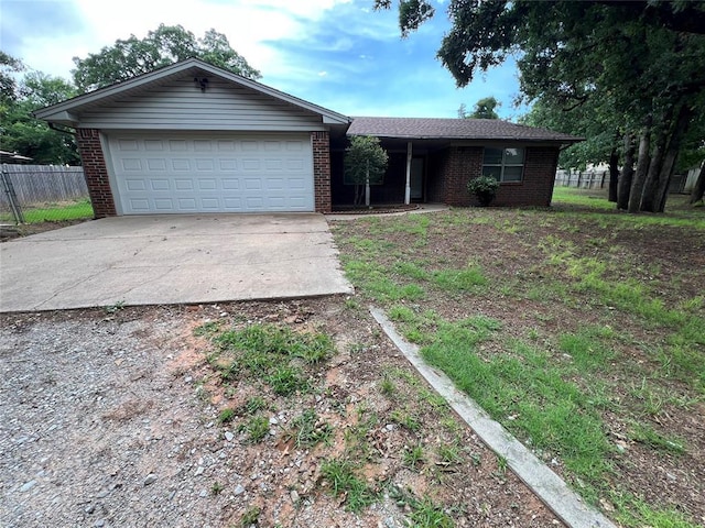 3014 S Mission St, Anadarko, OK 73005 - ranch-style home with concrete driveway, brick siding, and a garage