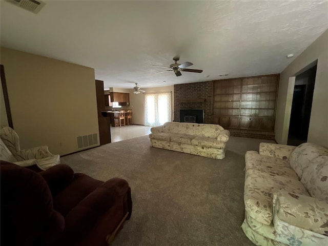 3014 S Mission St, Anadarko, OK 73005 - living area featuring ceiling fan, a brick fireplace, and carpet