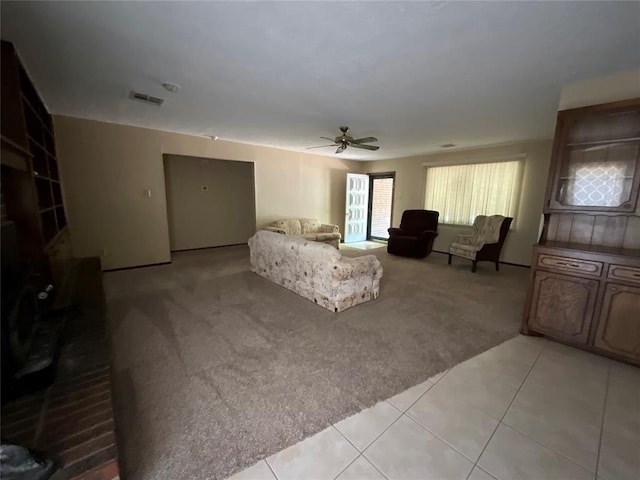 3014 S Mission St, Anadarko, OK 73005 - living room featuring light carpet, a ceiling fan, and light tile patterned flooring