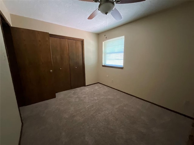 3014 S Mission St, Anadarko, OK 73005 - unfurnished bedroom featuring light carpet, a closet, and ceiling fan