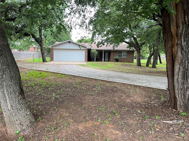 3014 S Mission St, Anadarko, OK 73005 - ranch-style house with brick siding, a garage, and asphalt driveway