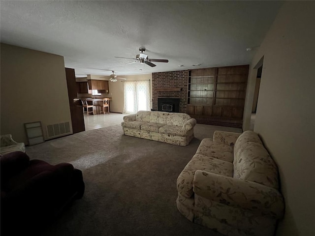 3014 S Mission St, Anadarko, OK 73005 - living area with a ceiling fan, a brick fireplace, and light colored carpet