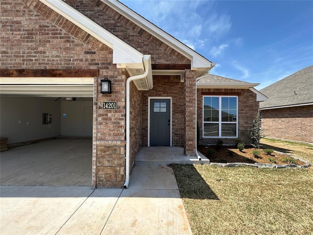 14201 Giverny Ave, Yukon, OK 73099 - entrance to property featuring concrete driveway, brick siding, and a garage