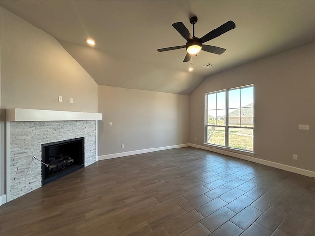 14201 Giverny Ave, Yukon, OK 73099 - unfurnished living room with vaulted ceiling, ceiling fan, baseboards, recessed lighting, and a stone fireplace