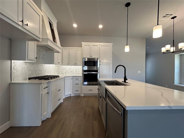 14201 Giverny Ave, Yukon, OK 73099 - kitchen featuring stainless steel appliances, a sink, dark wood-style floors, white cabinets, and tasteful backsplash