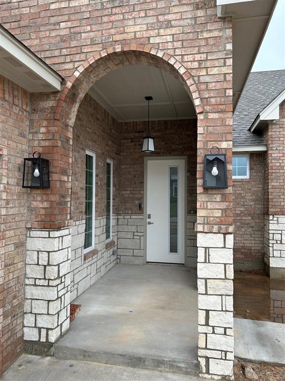 10109 NW 100th St, Yukon, OK 73099 - entrance to property with brick siding and a shingled roof
