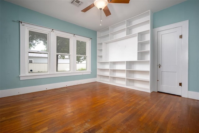 229 N Locust St, Pauls Valley, OK 73075 - unfurnished room featuring hardwood / wood-style floors, ceiling fan, baseboards, and built in shelves