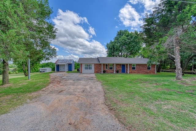 272 W Water Front Dr, Ninnekah, OK 73067 - ranch-style house featuring asphalt driveway, an outdoor structure, brick siding, and a front yard