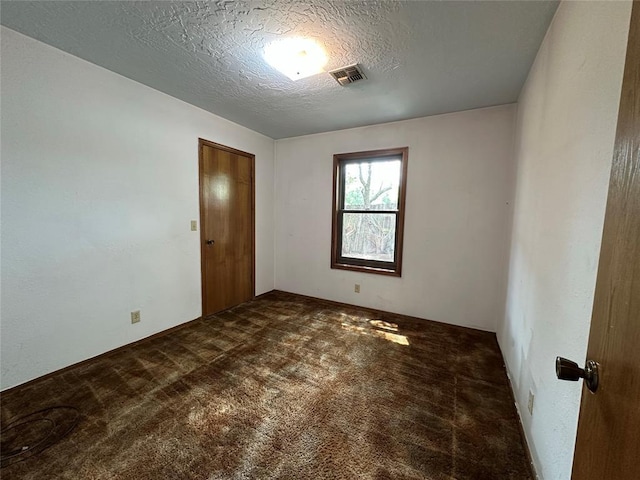2308 Lynn Ln, Weatherford, OK 73096 - spare room featuring carpet floors and a textured ceiling