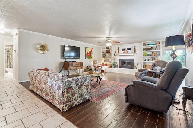 106 Dee Dee Dr, Shawnee, OK 74804 - living room with a textured ceiling, ceiling fan, ornamental molding, a brick fireplace, and baseboards