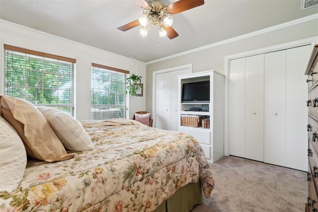 106 Dee Dee Dr, Shawnee, OK 74804 - bedroom featuring light colored carpet, ornamental molding, multiple closets, and a ceiling fan