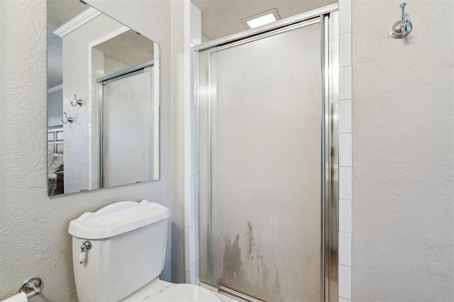 106 Dee Dee Dr, Shawnee, OK 74804 - full bath featuring a textured wall, a shower stall, and toilet