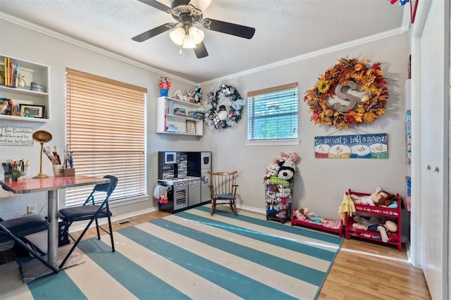 106 Dee Dee Dr, Shawnee, OK 74804 - office area featuring wood finished floors, ornamental molding, ceiling fan, a textured ceiling, and baseboards