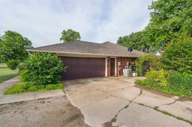 106 Dee Dee Dr, Shawnee, OK 74804 - single story home featuring central AC, an attached garage, driveway, brick siding, and a shingled roof