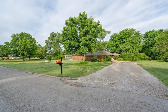 106 Dee Dee Dr, Shawnee, OK 74804 - view of front of property with a front lawn and asphalt driveway