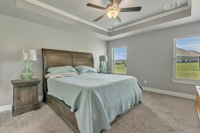 2383 Fox Ln, Blanchard, OK 73010 - bedroom featuring a tray ceiling, carpet flooring, baseboards, and ceiling fan