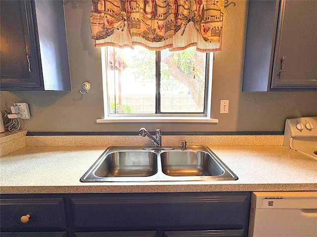 900 Hairston St, Altus, OK 73521 - kitchen featuring a sink, dishwasher, and light countertops