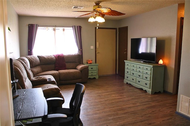 900 Hairston St, Altus, OK 73521 - living room with a ceiling fan, dark wood-style flooring, and a textured ceiling