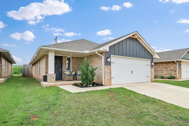 19908 Taggert Dr, Edmond, OK 73012 - view of front of home with board and batten siding, a front yard, an attached garage, driveway, and brick siding