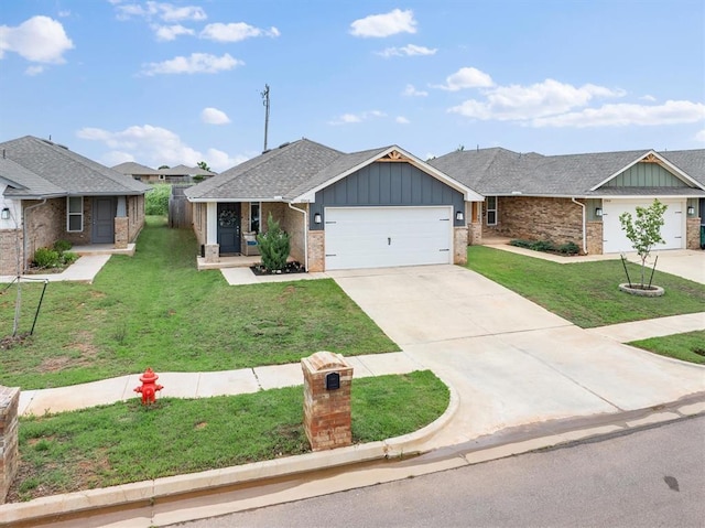 19908 Taggert Dr, Edmond, OK 73012 - view of front of home with board and batten siding, a garage, a front yard, concrete driveway, and brick siding