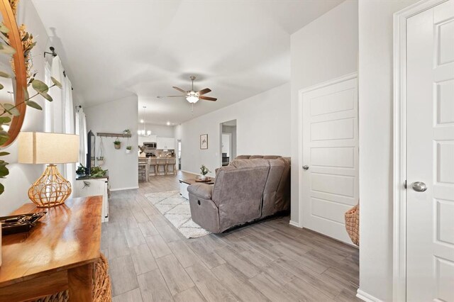 19908 Taggert Dr, Edmond, OK 73012 - living area with ceiling fan, light wood finished floors, and baseboards