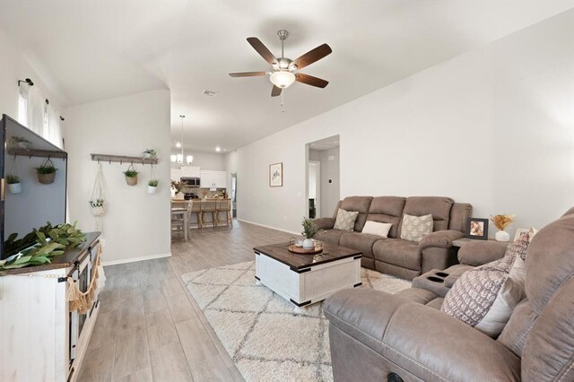 19908 Taggert Dr, Edmond, OK 73012 - living area featuring a ceiling fan, baseboards, light wood-style flooring, and lofted ceiling