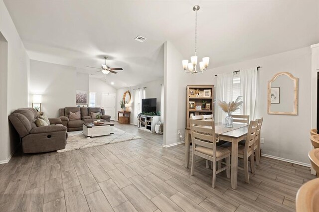 19908 Taggert Dr, Edmond, OK 73012 - dining area with lofted ceiling, a ceiling fan, plenty of natural light, a chandelier, and light wood-style floors