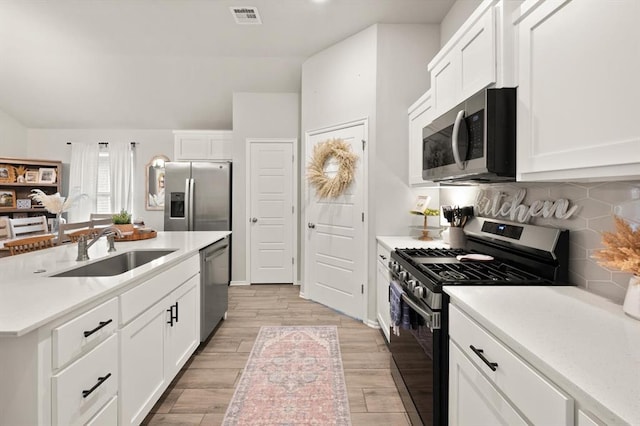 19908 Taggert Dr, Edmond, OK 73012 - kitchen featuring appliances with stainless steel finishes, a sink, and light countertops