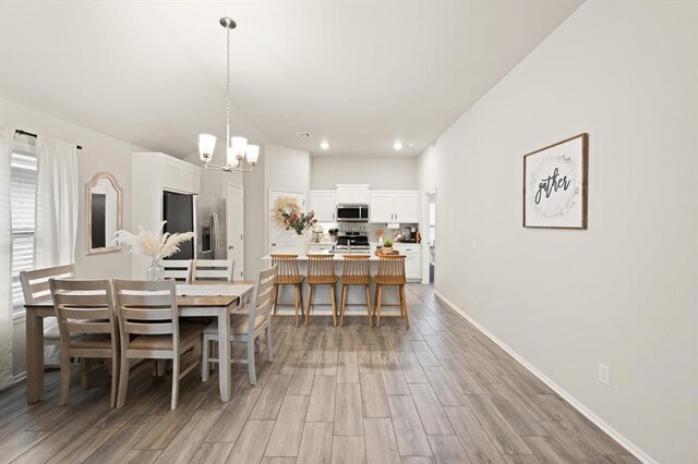 19908 Taggert Dr, Edmond, OK 73012 - dining space featuring a chandelier, light wood-type flooring, recessed lighting, and baseboards