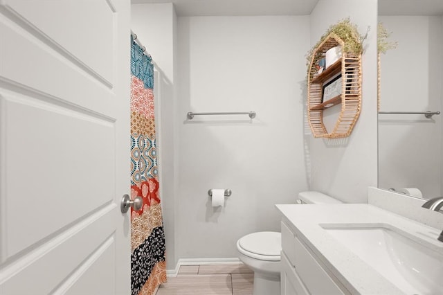 19908 Taggert Dr, Edmond, OK 73012 - bathroom with toilet, vanity, and baseboards
