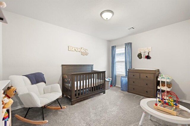 19908 Taggert Dr, Edmond, OK 73012 - carpeted bedroom featuring a nursery area and baseboards