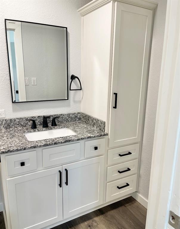 1304 W Walnut St, Tecumseh, OK 74873 - bathroom with vanity and wood finished floors