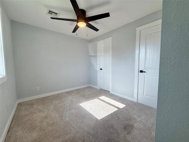 1304 W Walnut St, Tecumseh, OK 74873 - unfurnished bedroom featuring carpet and a ceiling fan