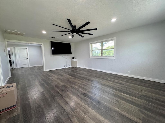 1304 W Walnut St, Tecumseh, OK 74873 - unfurnished living room featuring ceiling fan, dark wood-type flooring, recessed lighting, and a textured ceiling