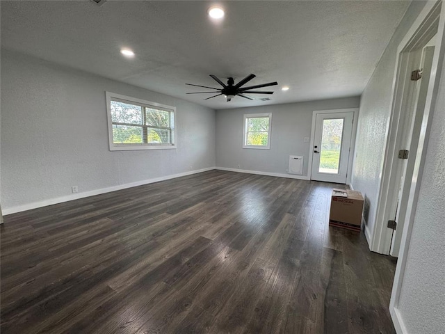 1304 W Walnut St, Tecumseh, OK 74873 - empty room featuring dark wood-type flooring, ceiling fan, recessed lighting, and a textured wall