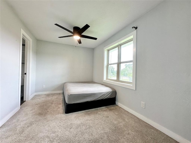1304 W Walnut St, Tecumseh, OK 74873 - carpeted bedroom with baseboards and a ceiling fan