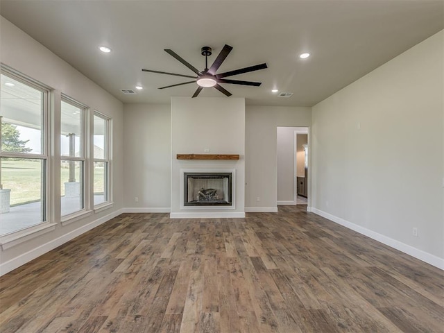 5812 Cimarron Mnr, Guthrie, OK 73044 - unfurnished living room featuring wood finished floors, a fireplace, recessed lighting, and ceiling fan