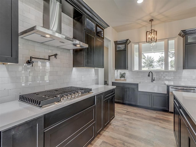 5812 Cimarron Mnr, Guthrie, OK 73044 - kitchen featuring wall chimney exhaust hood, backsplash, light countertops, and recessed lighting