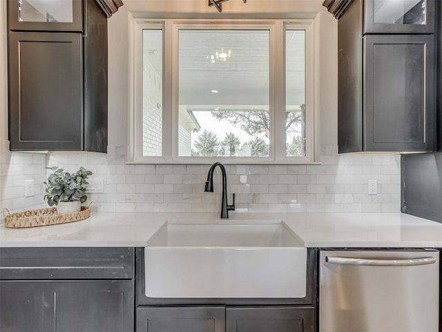 5812 Cimarron Mnr, Guthrie, OK 73044 - kitchen featuring stainless steel dishwasher, light countertops, decorative backsplash, and glass insert cabinets