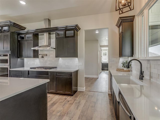 5812 Cimarron Mnr, Guthrie, OK 73044 - kitchen featuring wall chimney range hood, light countertops, tasteful backsplash, and recessed lighting