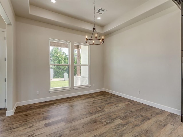 5812 Cimarron Mnr, Guthrie, OK 73044 - unfurnished room featuring a chandelier, a raised ceiling, dark wood-type flooring, and recessed lighting