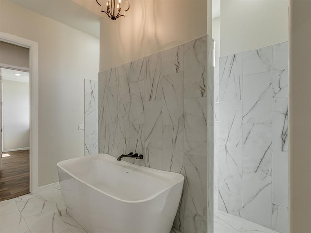 5812 Cimarron Mnr, Guthrie, OK 73044 - full bath with tile walls, marble look tiles, a freestanding tub, and a chandelier