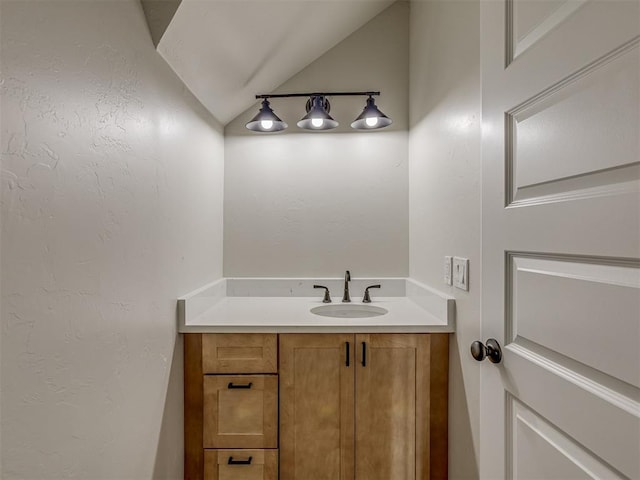 5812 Cimarron Mnr, Guthrie, OK 73044 - bathroom featuring vaulted ceiling and vanity