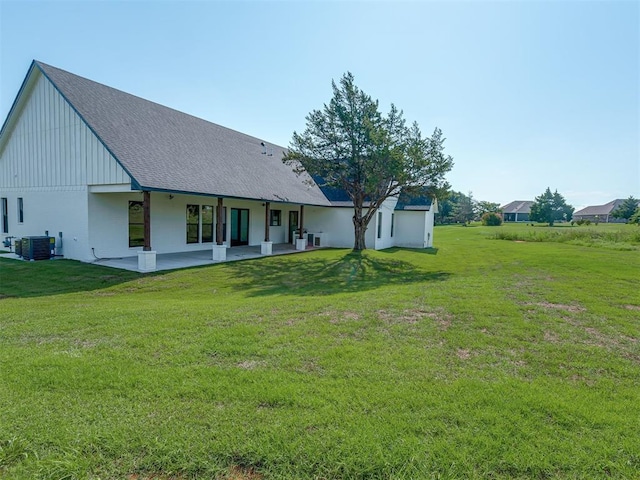 5812 Cimarron Mnr, Guthrie, OK 73044 - back of property featuring a lawn, a patio, and board and batten siding