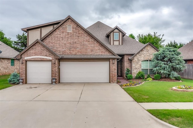 328 SW 175th Ter, Oklahoma City, OK 73170 - view of front of home with concrete driveway, an attached garage, roof with shingles, brick siding, and stone siding