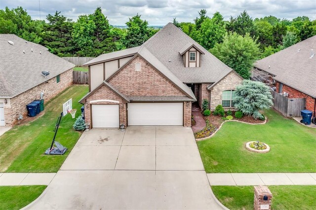328 SW 175th Ter, Oklahoma City, OK 73170 - view of front of house featuring brick siding, an attached garage, driveway, and roof with shingles